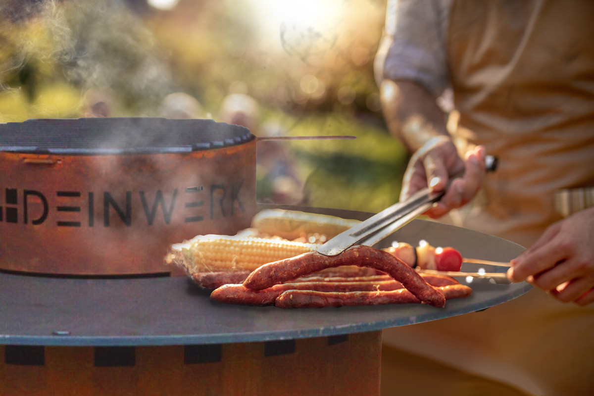 Young Man Grilling Meat On Barbecue